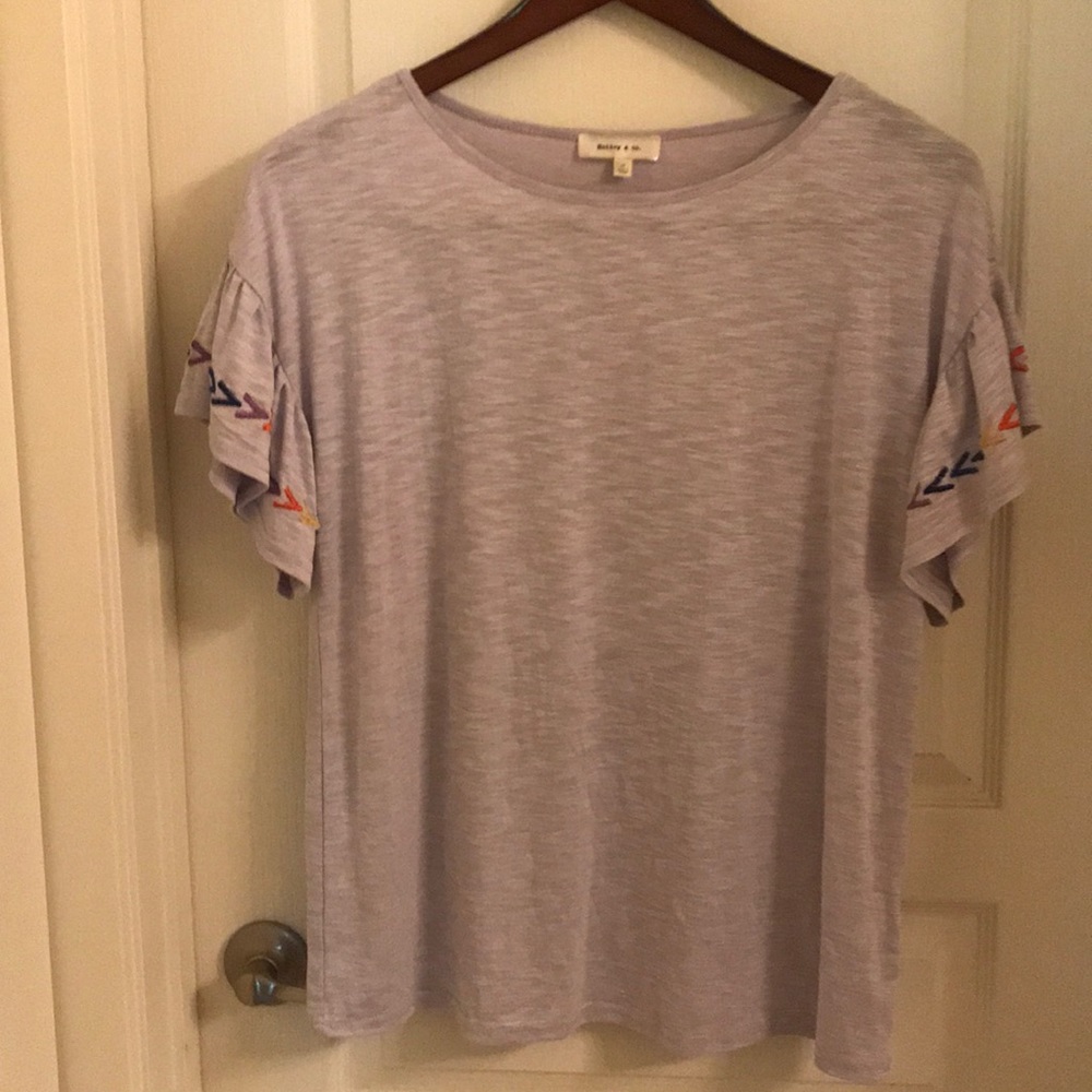 Embroidered flutter sleeve shirt.